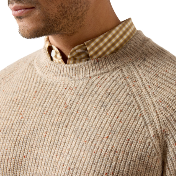 Ariat Men's Heddon Sweater Varient Oatmeal Heather. Close up of Man wearing a beige coloured wool jumper and a cheque shirt. 