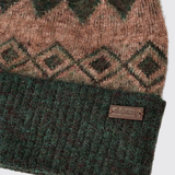 Dubarry Of Ireland Coolroe Bobble Hat Variant Olive Multi. Close-up of a knit beanie with a brown and dark green geometric pattern on the upper section and a dark green ribbed cuff. A small brown leather patch on the cuff is embossed with the brand name 'dubarry'.