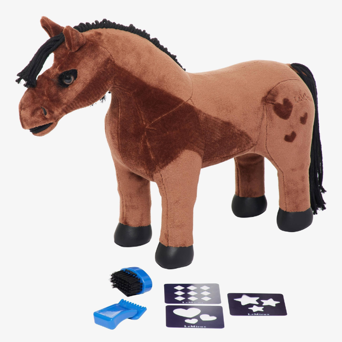 LeMieux Toy Pony Variant Gracie. A plush toy horse in brown and tan with a black mane, tail, and hooves, shown on a white background with small grooming accessories and pattern cards below it.