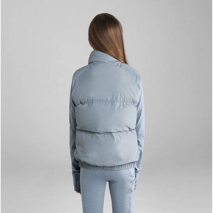 Young person wearin grey gilet on grey background