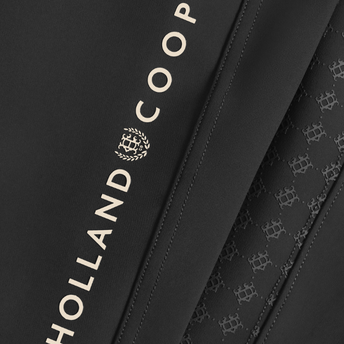 Holland Cooper Chiltern Contour Breeches Variant Colour Black.
Close up of brand name 'Holland Cooper' on black material.