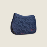 Ariat Evolve Saddle Pad Varient Navy. Navy saddle pad with red 'Ariat' detailing on a beige background.