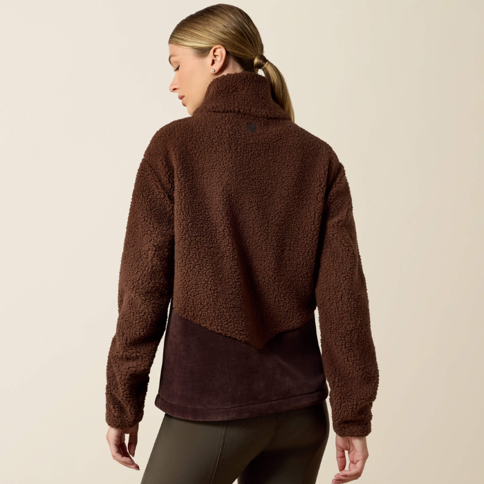 Ariat Ladies Laviolette Full Zip Jacket Variant Chocolate Plum. A woman shown from the back wearing a brown sherpa fleece cropped jacket with a darker brown solid lower panel, paired with dark olive leggings, against a plain beige studio background.