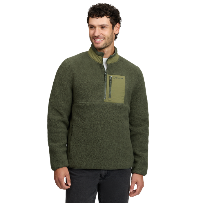 LeMieux AW26 Mens Borg Half Zip Sweat Varient Olive. A man wearing an olive green fleece pullover jacket with a half-zip collar and a chest pocket, photographed against a plain white background.