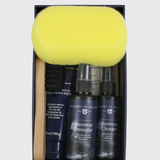 A boxed footwear care set from Dubarry of Ireland, featuring a bright yellow sponge, a wooden-handled brush, and two black bottles labeled Footwear Protector and Footwear Cleaner.
