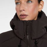 Close-up of a person wearing a dark brown hooded jacket on a white background