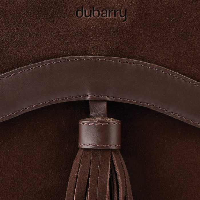 Dubarry Of Ireland Monart Bag Variant Cigar. Close-up detail of a dark brown suede and leather bag featuring a tassel and the debossed brand name 'dubarry' at the top.
