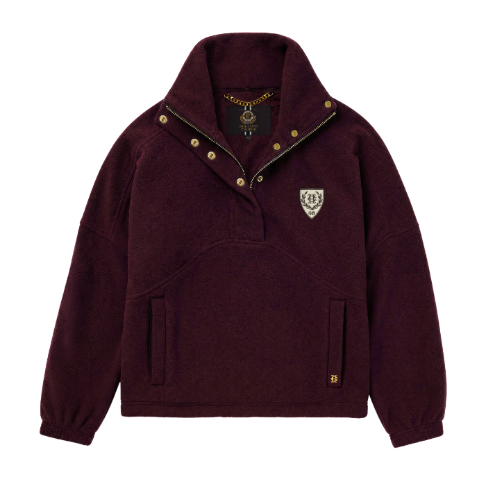 Holland Cooper Cranborne Over Head Fleece Variant Mulberry. A burgundy fleece pullover jacket with a stand-up collar, gold snap buttons, and a small embroidered shield logo on the left chest, shown against a plain white background.