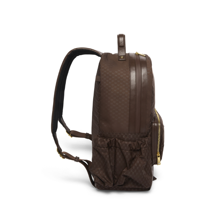 Holland Cooper Burghley Backpack Variant Colour Walnut.
A dark brown backpack with a textured monogram pattern, brown leather trim, and gold-tone hardware, shown from a side profile view on a white background.