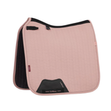 LeMieux AW26 Essence Dressage Square Varient Wild Rose. A dusty pink quilted equestrian saddle pad with black trim and a black interior lining, featuring the LeMieux brand name on a black patch at the front.