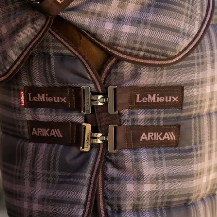 Close up of a quilted rug with with a T-bar fastening and LeMieux/ARIKA branding. 
