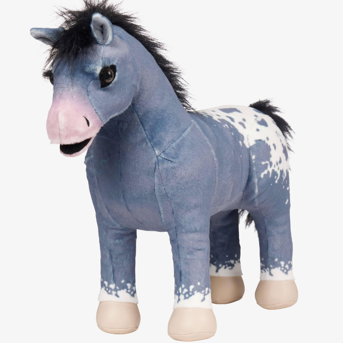 LeMieux Toy Pony Variant Comet. A plush toy horse with a dusty blue body, white paint-like spots, a pink muzzle, and a black mane, shown against a plain white background.