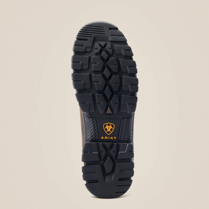 The treaded black rubber outsole of an Ariat boot, shown from a top-down view against a light beige background.