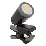 A black clip-on LED work light with a bright white illuminated bulb, against a white background. 