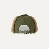 Green cap with brown ear flaps on a light beige background