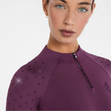 Plum top with embelishments on the shoulder on a white background