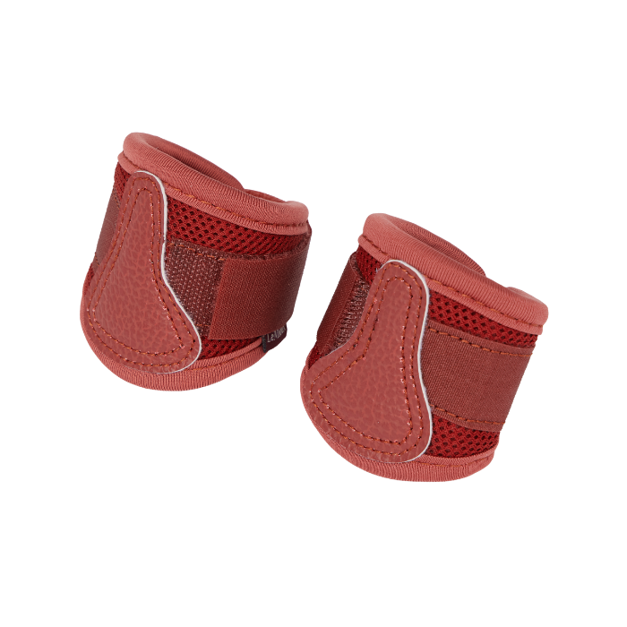 LeMieux AW26 Toy Pony Mesh Brushing Boots Variant Colour Russet. A pair of toy pony leg wraps in russet colour wirh contrasting trim on white background.