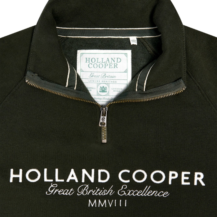 Holland Cooper Sporting Goods Zip Henley variant Racting Green. Close up of Holland Cooper 1/4 zip with a gold zip and white Holland Cooper lettering. 