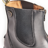 Close-up of a gray leather boot with a textured panel and brand logo on a white background