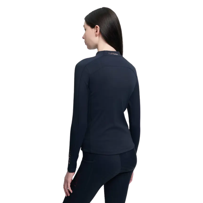 Person in Navy long sleeved top and leggings on white background