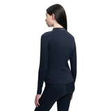 Person in Navy long sleeved top and leggings on white background