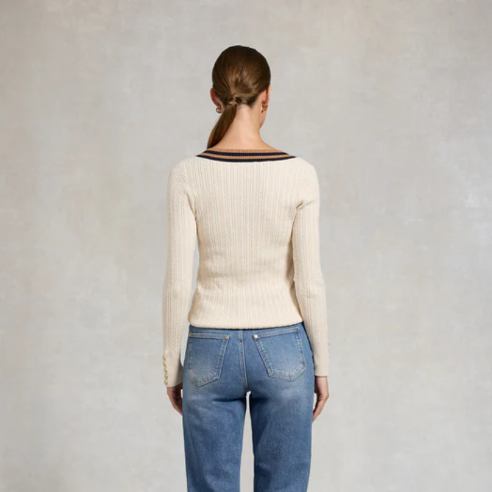 Person wearing cream jumper and jeans