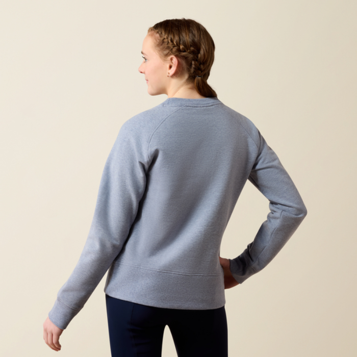 Ariat Youth Martine Sweatshirt AW26 Varient Blue Grey Lets Play. Back of Girl wearing Blue jumper on a beige background.