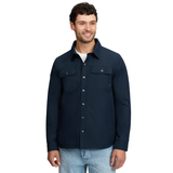 LeMieux AW26 Mens Showerproof Shacket Varient Navy. A man wearing a dark navy blue button-up shirt jacket with two chest flap pockets, shown against a plain white background.
