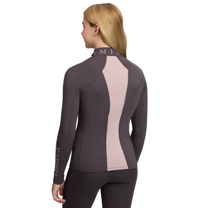 LeMieux AW26 Young Rider Mia Mesh Base Layer Varient Cocoa. A woman shown from the back wearing a long-sleeve athletic top in dark gray with a vertical light pink panel down the back, paired with dark leggings, against a plain white background.