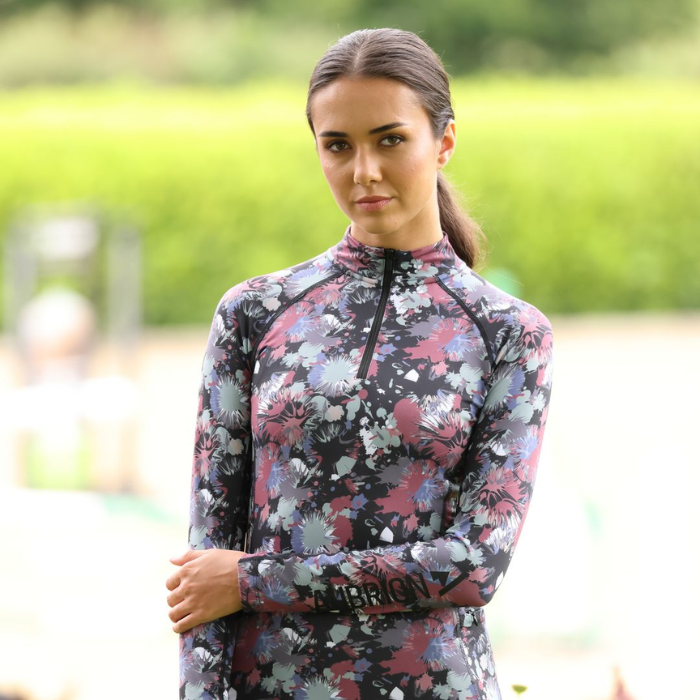 Rider wears the Shires Aubrion React Long Sleeve Base Layer in Abstract