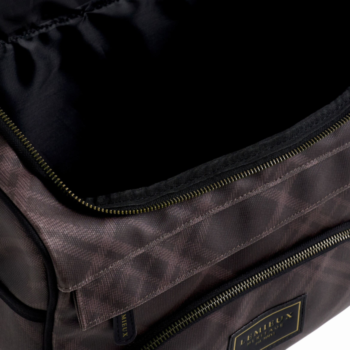 Close-up of a dark brown textured nylon bag with black zippers and a black interior, featuring a gold-bordered 'LE MIEUX' brand patch on the front.