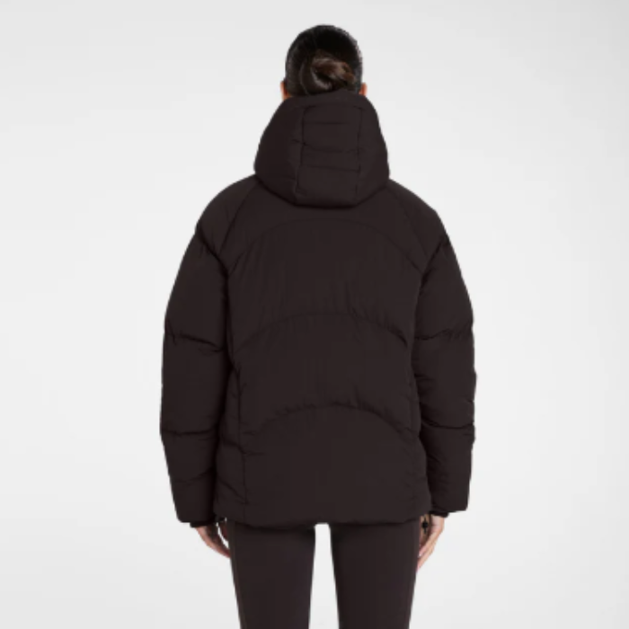 Back of person wearing a expresso puffer jacket on a white background