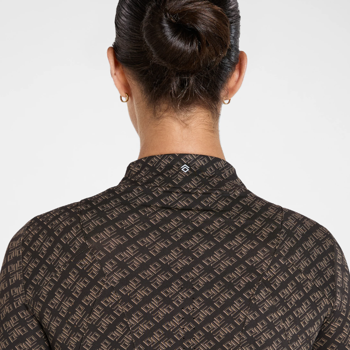 Back view of a woman wearing a dark brown collared shirt with a repeating beige geometric monogram pattern, set against a plain light gray background.