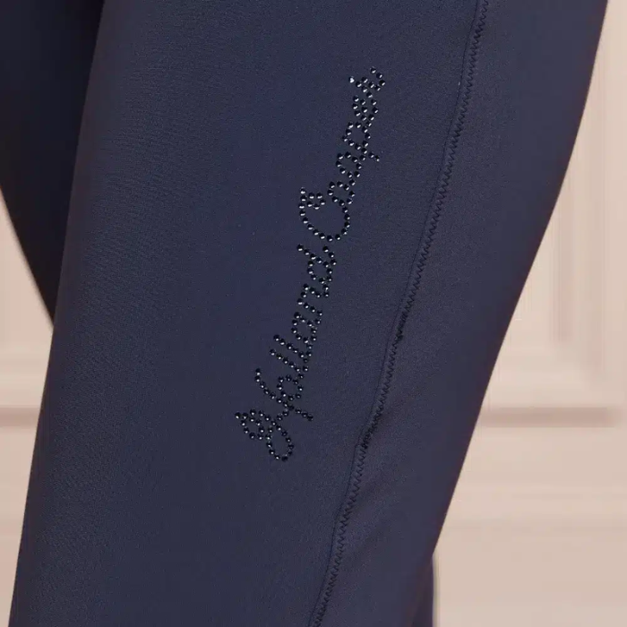blue leggings on one leg with holland cooper branding