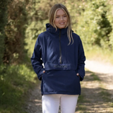 Reincoat Smock Pro Variant Midnight Navy.  Lady wearing a navy coat stood outside with 'REINCOAT' on the front. 
