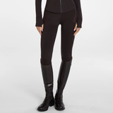 Aztec Diamond AW26 Core Leggings Full Seat Variant Espresso. Brown equestrian riding breeches with textured knee panels, shown on a model wearing matching black riding boots against a light gray studio background.
