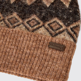 Dubarry Of Ireland Coolroe Bobble Hat Variant Oat Multi. Close-up of a knit beanie with a brown and beige geometric pattern on the upper section and a ribbed brown cuff. A small brown leather patch on the cuff reads 'dubarry'.