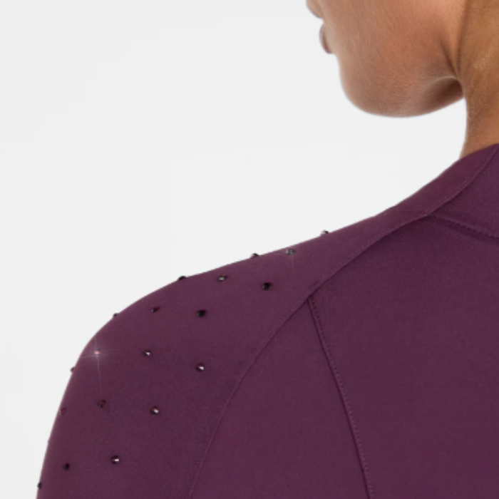 Close-up of a purple garment with embellishments on a plain background