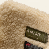 Ariat Wetherby H20 Insulated Variant Dark Earth. Close-up of a cream sherpa fleece garment with a green Ariat label and a 3M insulation label visible.