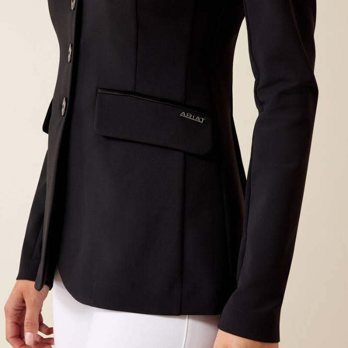 Black blazer with a visible brand logo on a neutral background