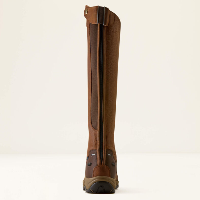 A tall brown leather riding boot shown from the back, featuring a central black zipper, brown leather panels, and a rugged brown and black sole, set against a plain off-white background.