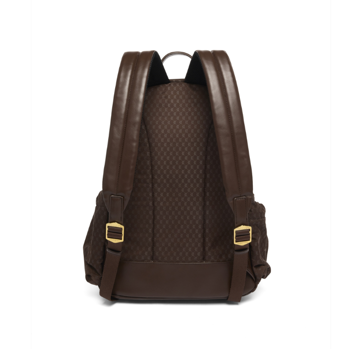 Holland Cooper Burghley Backpack Variant Colour Walnut.
A dark brown backpack shown from the back, featuring a textured honeycomb pattern, smooth brown shoulder straps, and gold-tone buckle details, set against a plain white background.