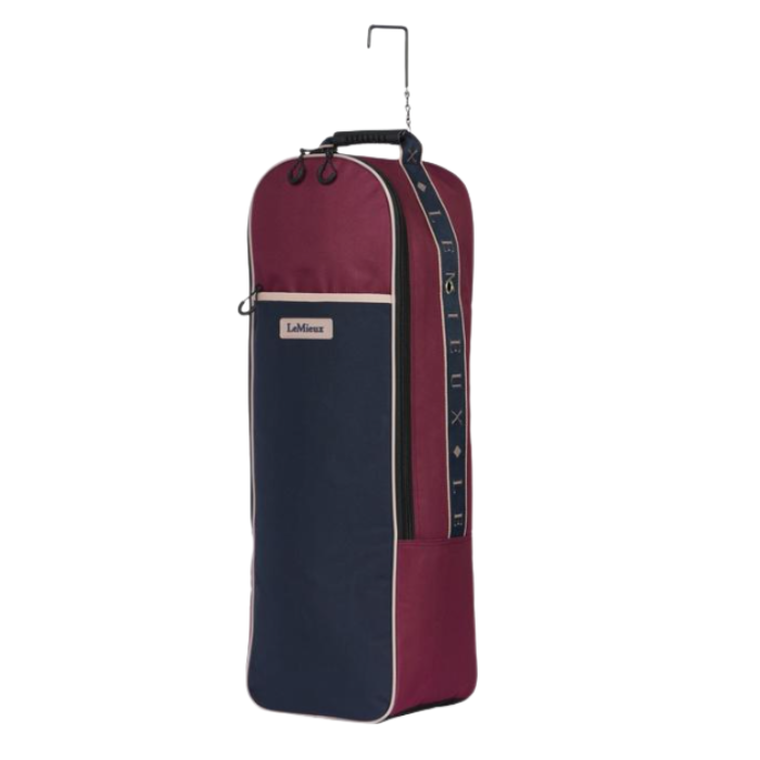 LeMieux AW26 Anatomical Bridle Bag Varient Blackberry. A tall, narrow LeMieux bridle bag in burgundy and navy blue, featuring a top hanging hook, a front zippered pocket with a brand label, and a vertical measurement scale on the side.