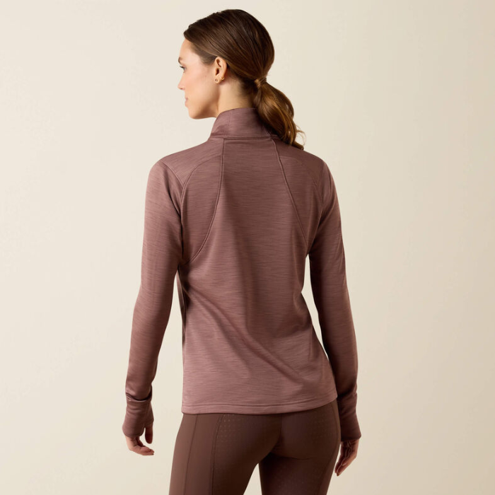 Ariat Ladies Team EQ 1/2 Zip Pullover Variant Twilight Mauve. A woman shown from the back wearing a long-sleeve athletic quarter-zip top in a dusty mauve-brown color, paired with matching leggings, against a plain beige studio background.