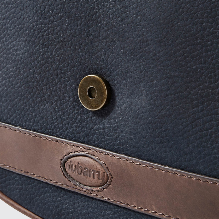 Close-up of a navy blue leather bag with a brown strap and Dubarry logo.
