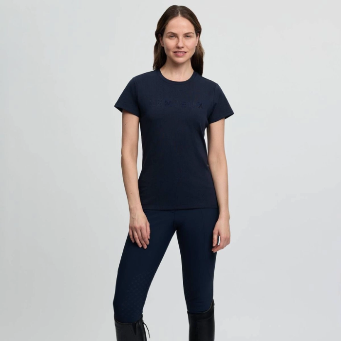 Woman wearing a navy blue outfit on a light gray background