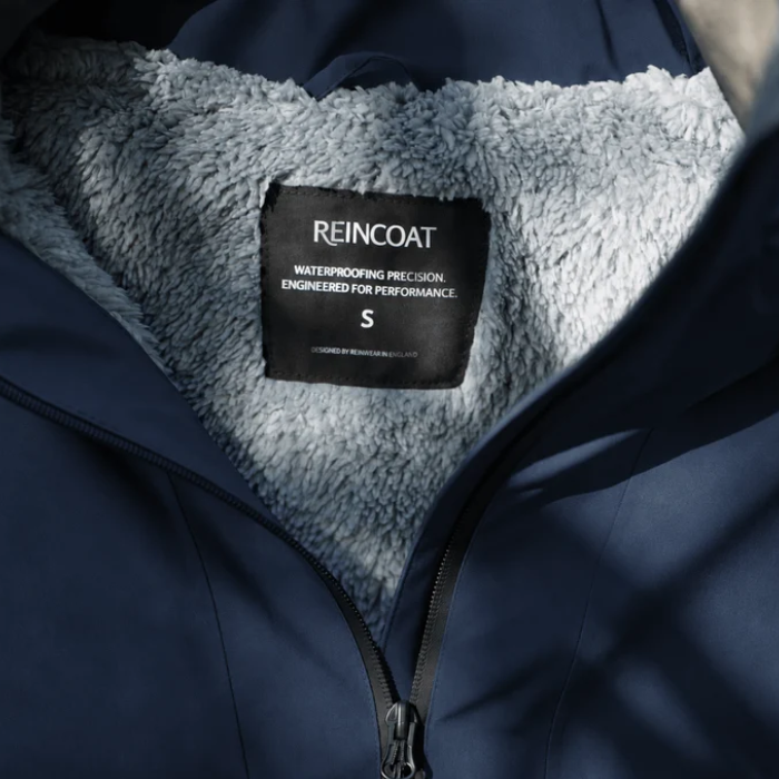 Reincoat Smock Pro Variant Midnight Navy. Inside of a navy jacket with a grey fleece lining. 