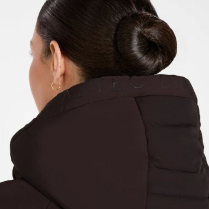 Person wearing a expresso coat with  branding on a white background