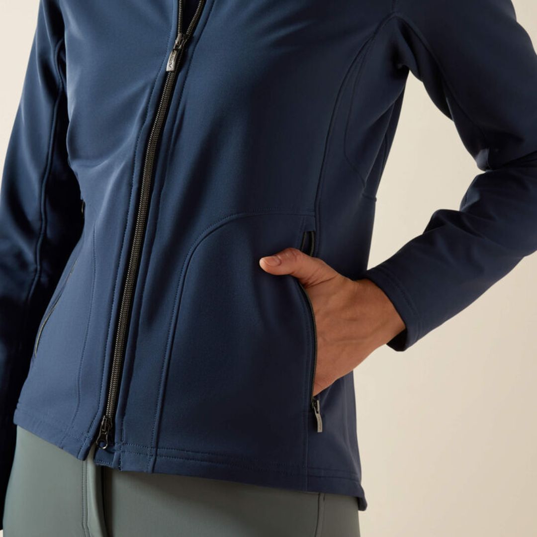 Navy blue jacket with a hand in the pocket on a beige background