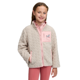 LeMieux AW26 Mini Thora Heart Fleece Varient Stone. A young girl smiling while wearing a light beige sherpa fleece jacket with pink trim and a pink chest pocket featuring a horse graphic, paired with pink leggings, against a plain white background.